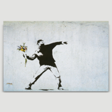 Banksy canvas home wall art featuring his work Rage The Flower Thrower love is in the air hanging on a beige wall. 